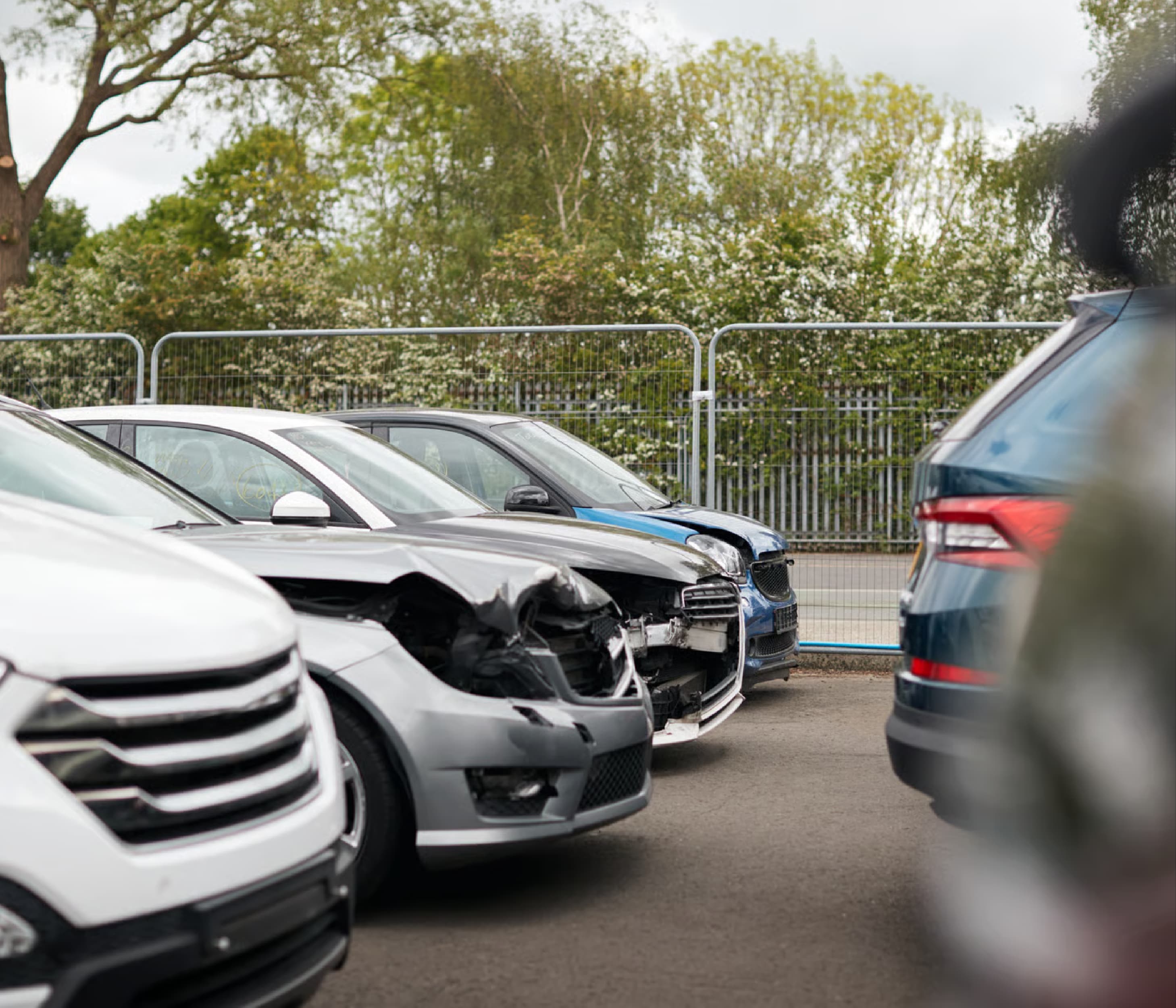 Damaged cars parked in a salvage yard