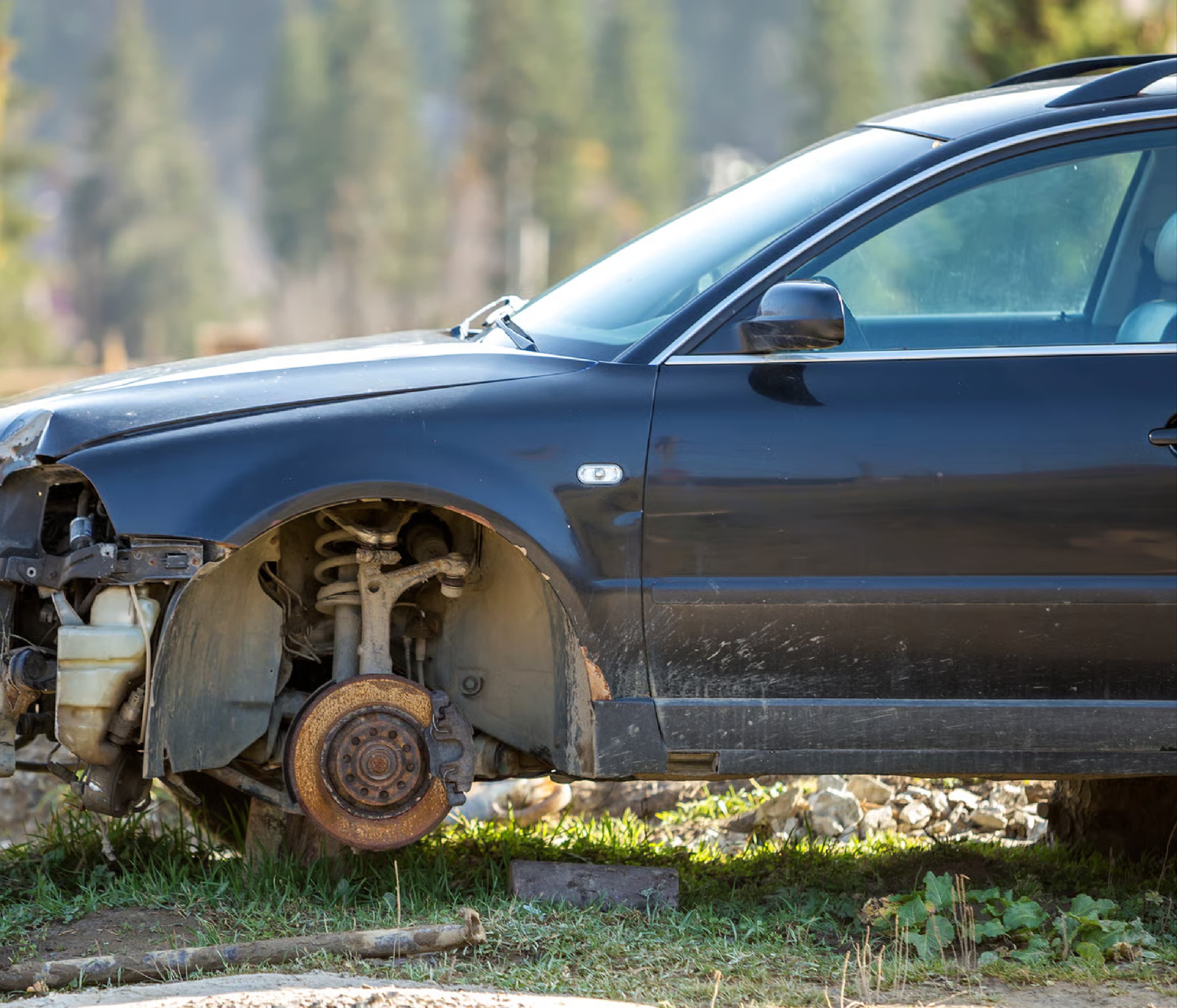 Junk car missing a front wheel