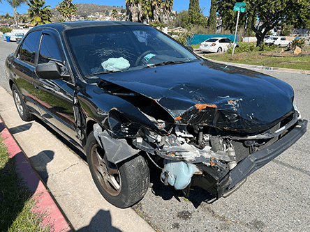 Black Honda Accord with front-end collision damage