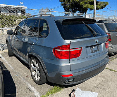 Blue BMW X5 SUV shown from the rear quarter