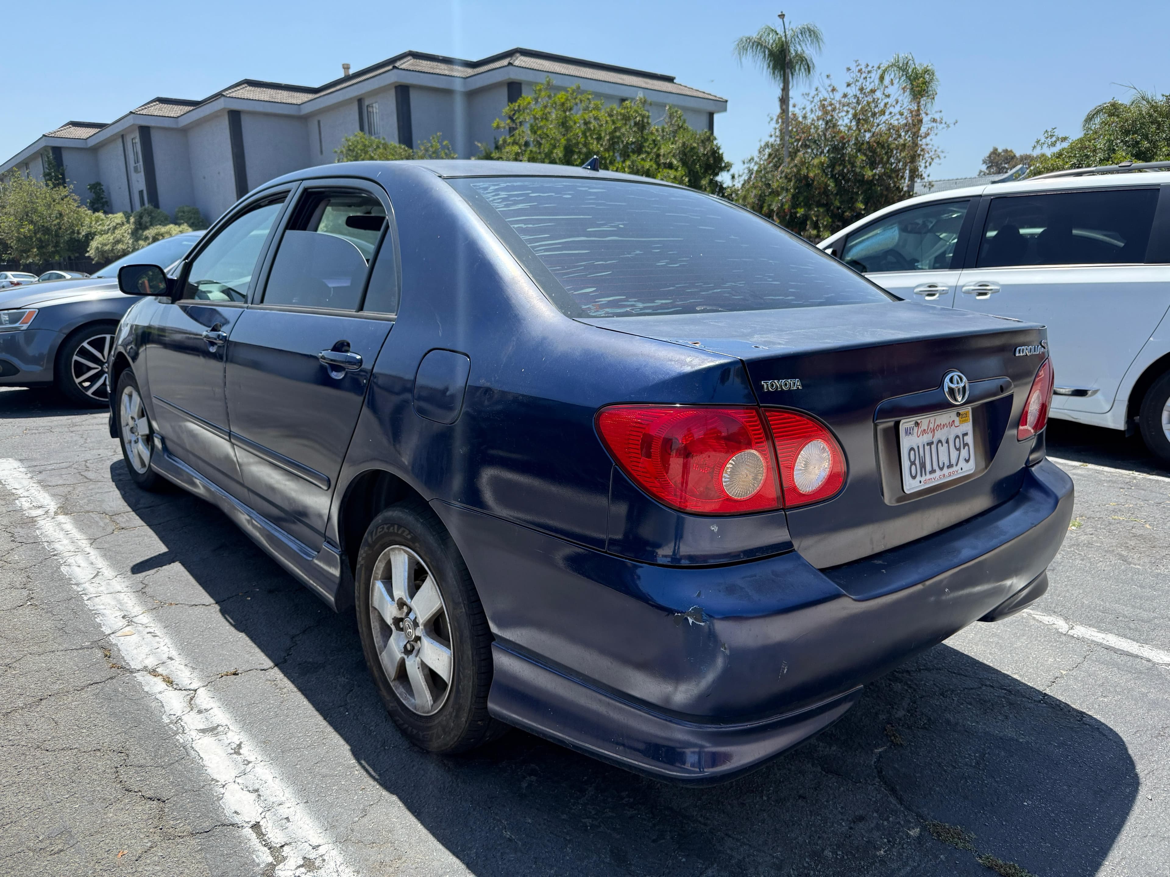 Blue Toyota Corolla with rear bumper damage