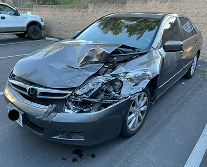 Gray Honda Accord with front-end collision damage