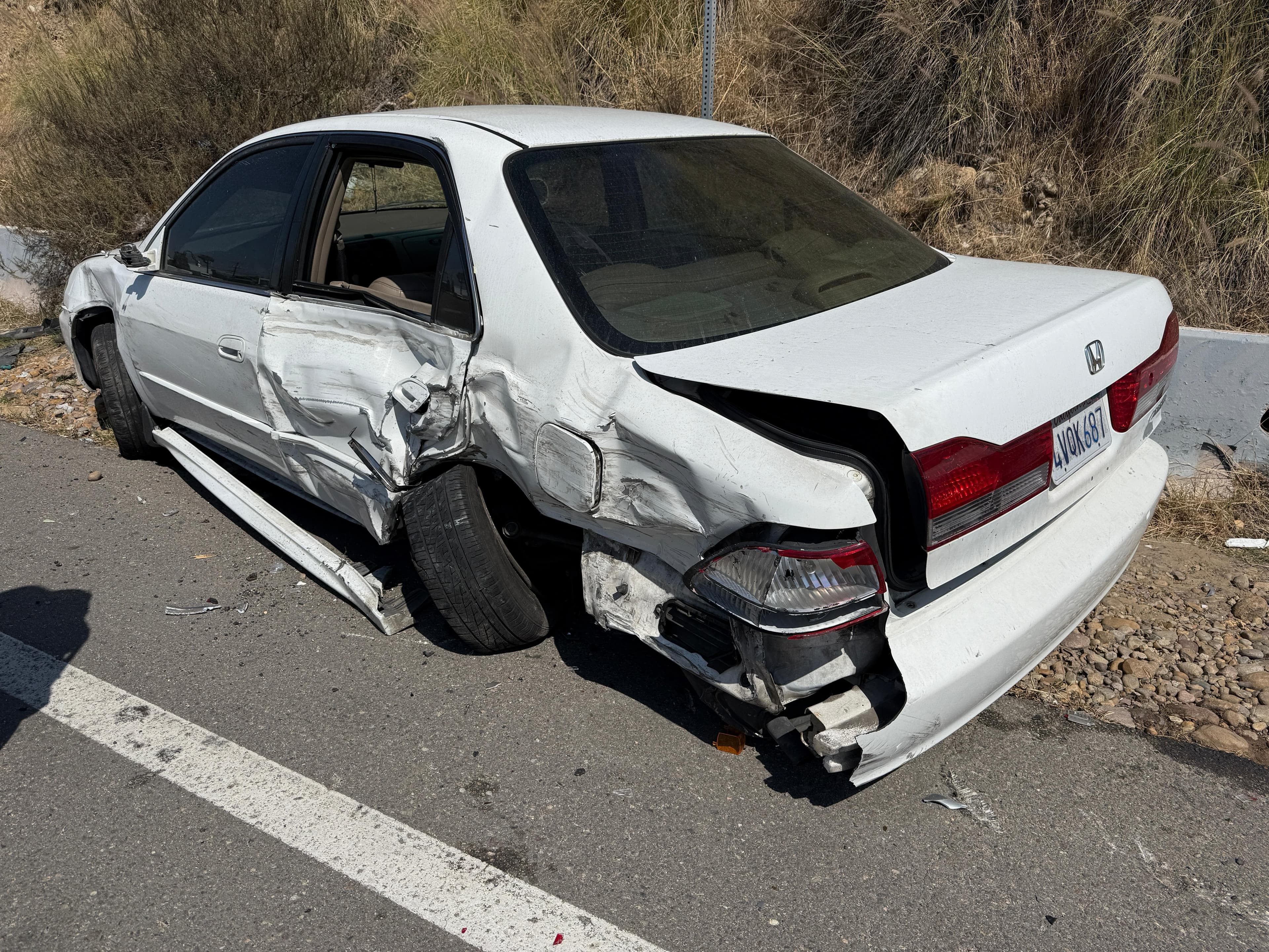 White Honda Accord with side and rear collision damage